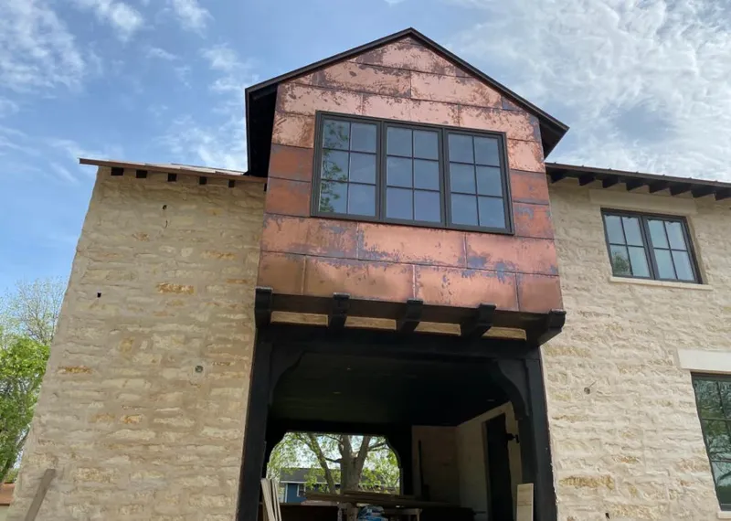 Copper metal panel facade on a stone building for Skylight Installation in Canby